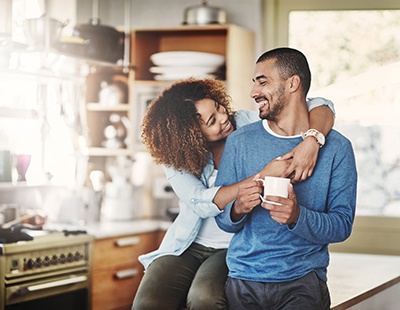 smiling, hugging, healthy couple in their kitchen